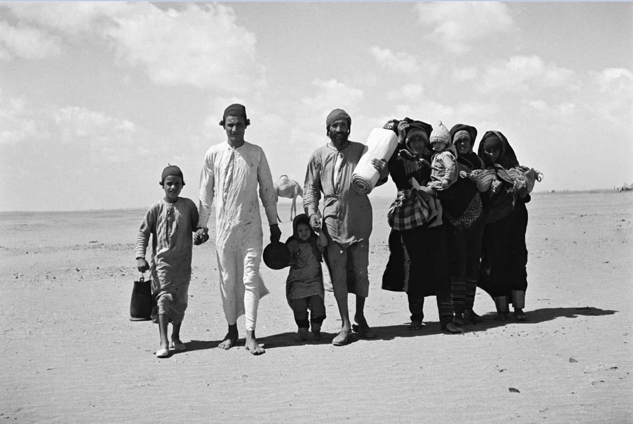 A Yemenite Jewish family walks to a transit camp near Aden on the way to Israel, 1949.