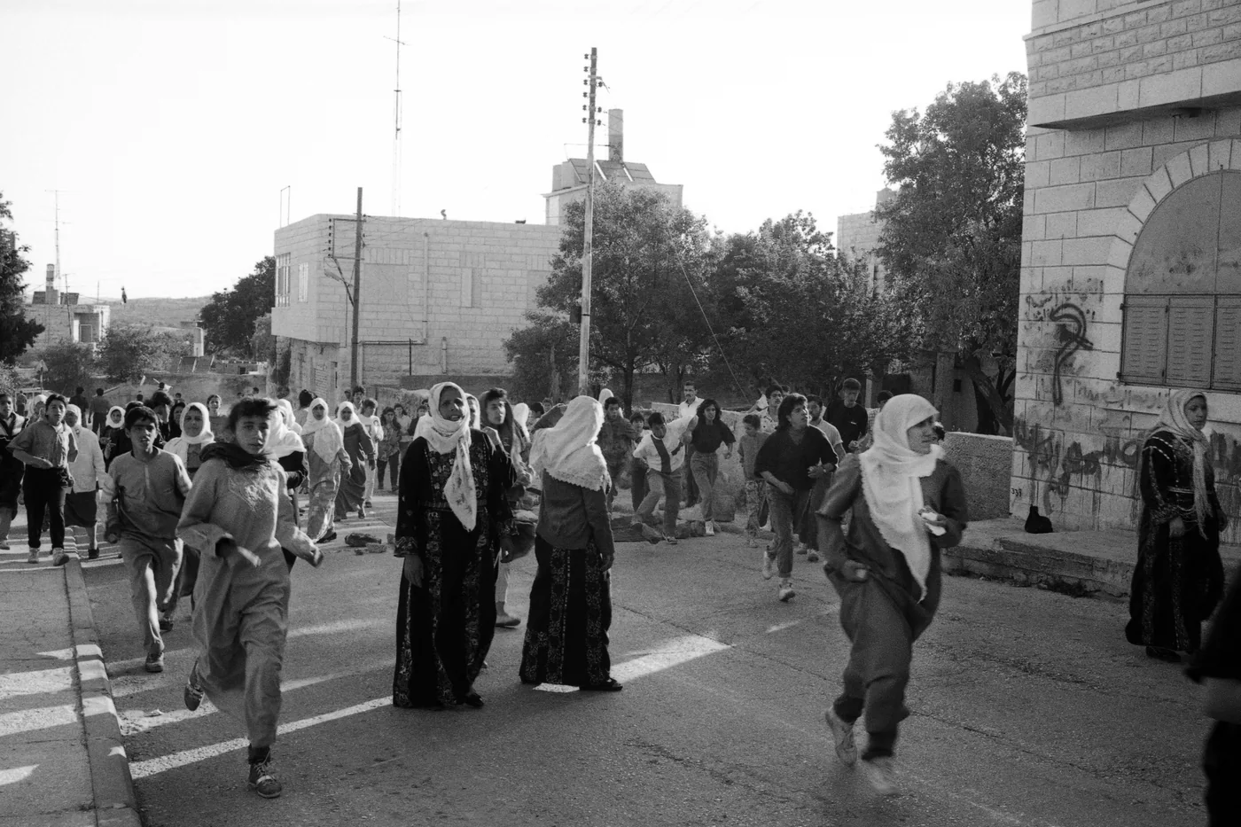 A Demonstration in the Streets of Ramallah, taken during the First Intifada, this photograph captures a demonstration roaming the streets of Ramallah.