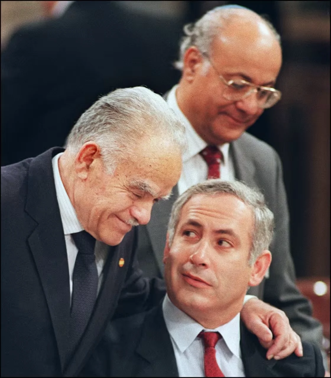Israeli Premier Yitzhak Shamir (L) speaking in Madrid with his advisor Benjamin Netanyahu (R) at the Madrid Middle East Peace conference, October 30 1991.